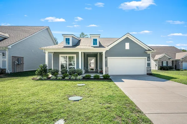 a front view of a house with a yard and garage