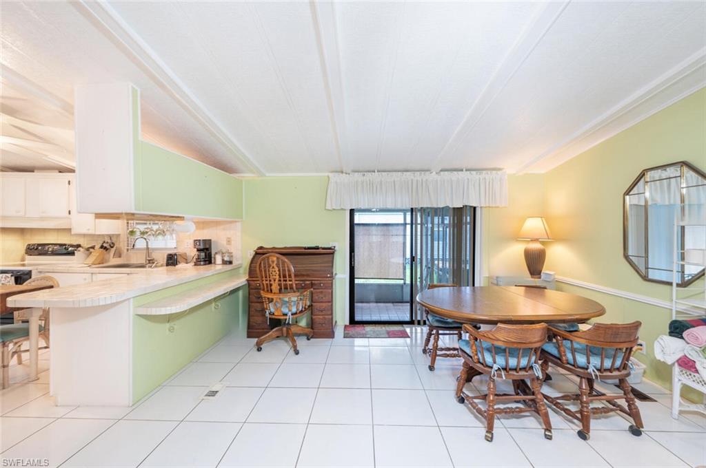130 Grassy Key Lane, Unit 37 Naples, FL 34114 - Photo 8 of 27 a room with stainless steel appliances kitchen island granite countertop furniture and a view of kitchen
