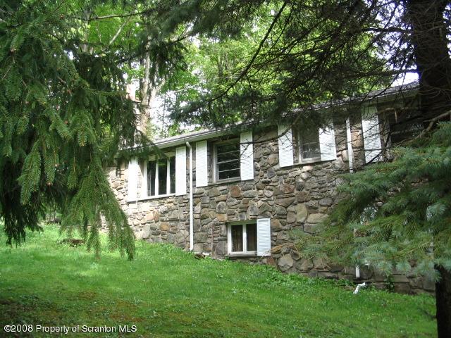 0 Spring Hill Road Sterling, PA 18463 - Photo 1 of 24 a front view of a house with a garden