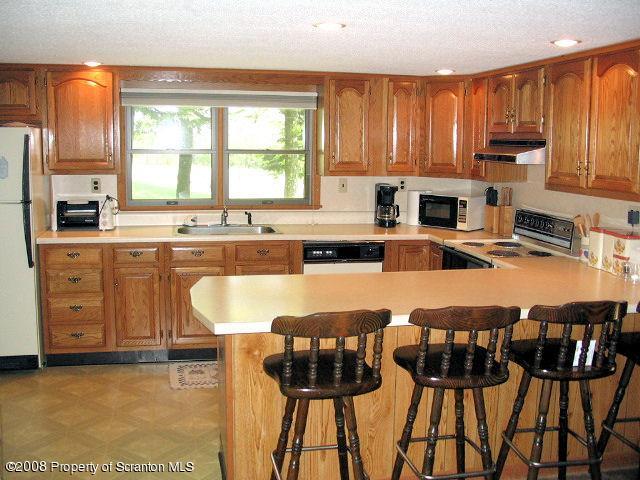 0 Spring Hill Road Sterling, PA 18463 - Photo 20 of 24 a kitchen with stainless steel appliances granite countertop a stove a sink dishwasher and cabinets with wooden floor