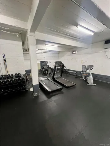 a living room with furniture gym equipment and a table