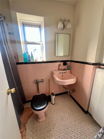 a bathroom with a sink a toilet and a mirror