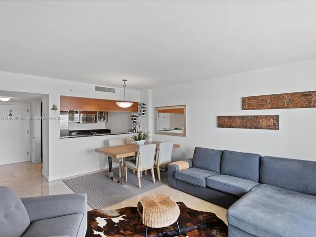 a living room with furniture and a dining table