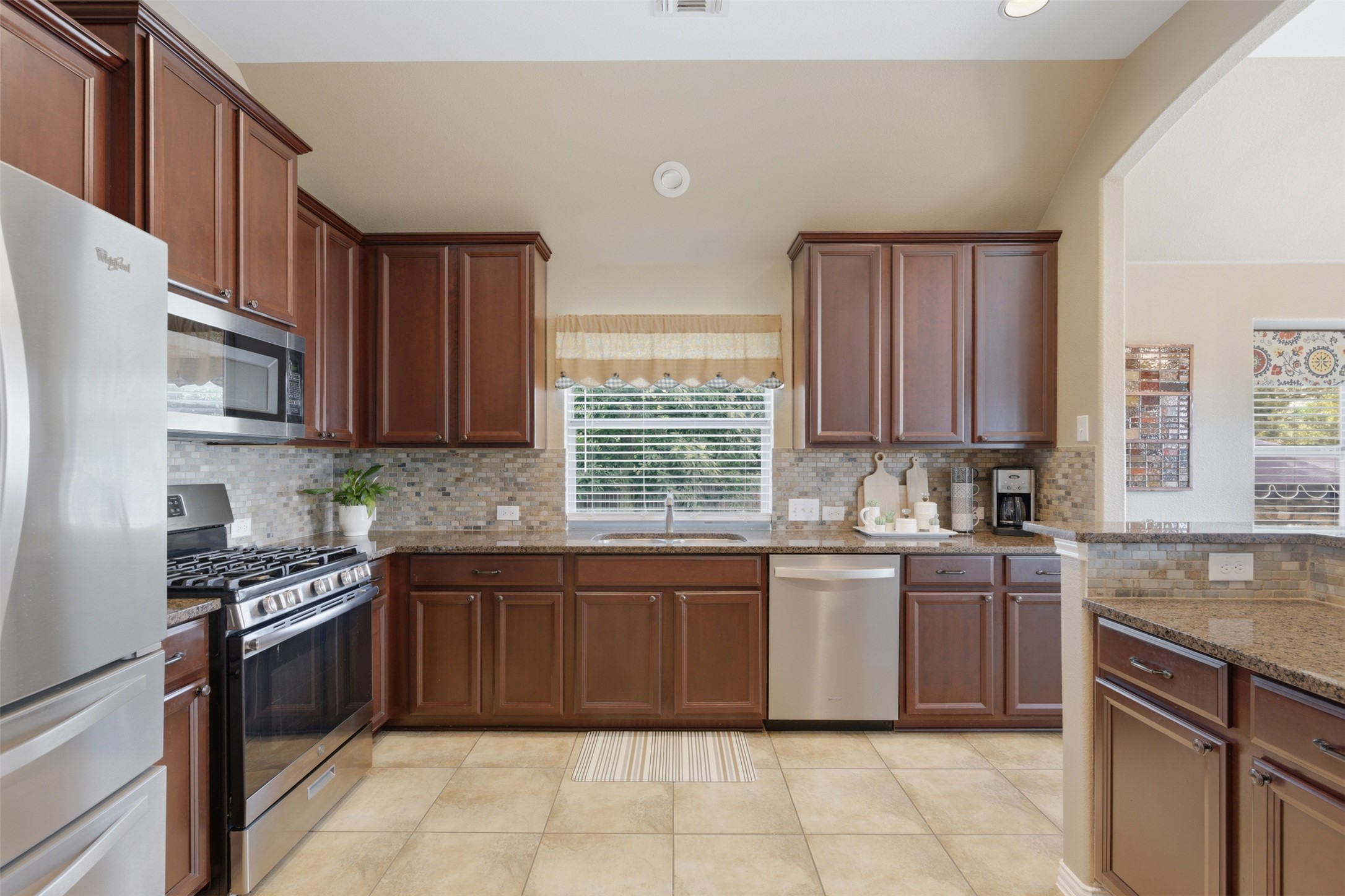 2568 Santa Barbara Loop Round Rock, TX 78665 - Photo 11 of 34 a kitchen with stainless steel appliances granite countertop a stove sink and cabinets