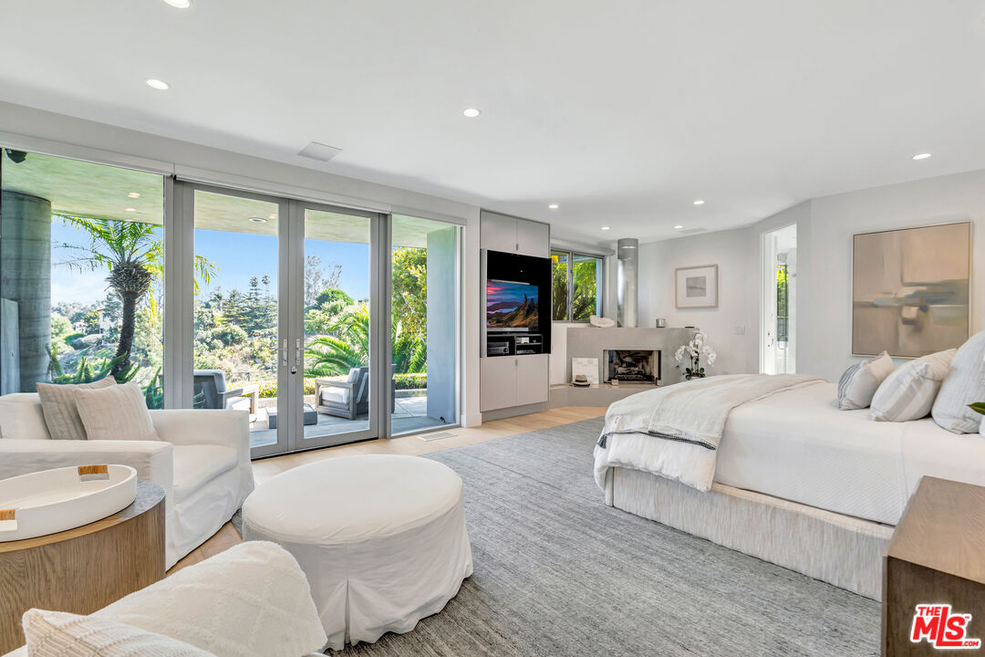 28775 Sea Ranch Way Malibu, CA 90265 - Photo 14 of 21 a bedroom with a large bed and windows