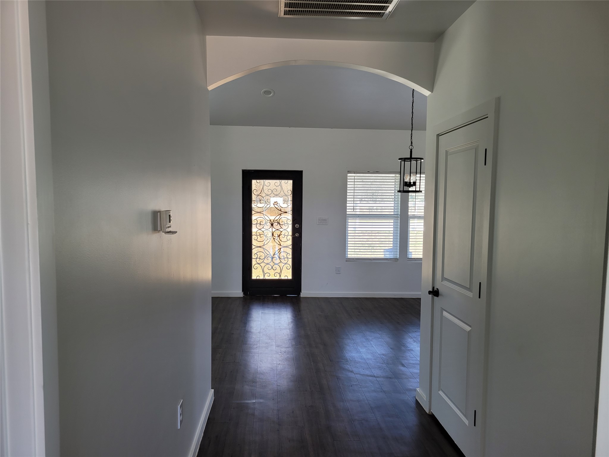 422 A Road Stockdale, TX 78160 - Photo 12 of 40 An inviting entry opens to a spacious living area, highlighted by elegant dark wood flooring and natural light.