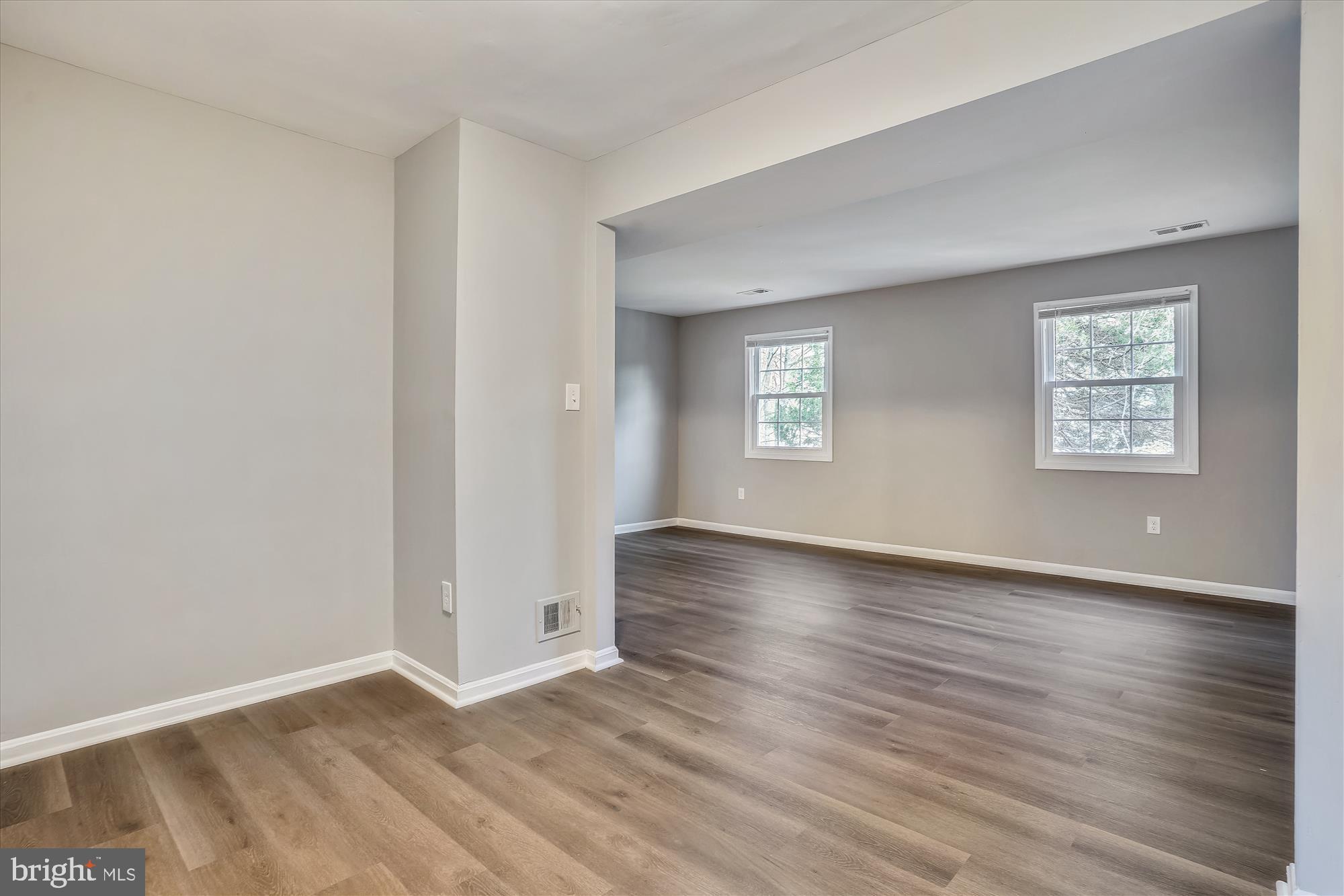 9202 Sprucewood Road Burke, VA 22015 - Photo 7 of 21 an empty room with wooden floor and windows