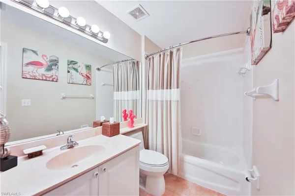 a bathroom with a sink vanity mirror and toilet