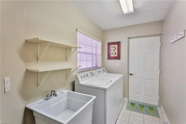 a utility room with a sink dryer and washer
