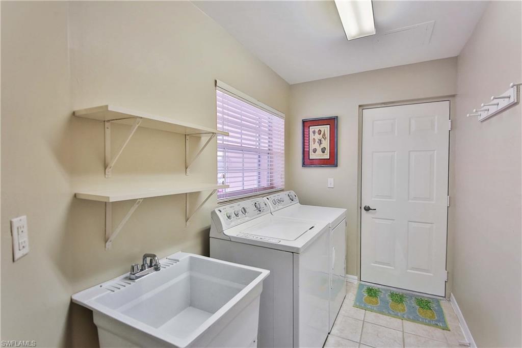 5105 Cedar Springs Drive, Unit 101 Naples, FL 34110 - Photo 22 of 30 a utility room with a sink dryer and washer