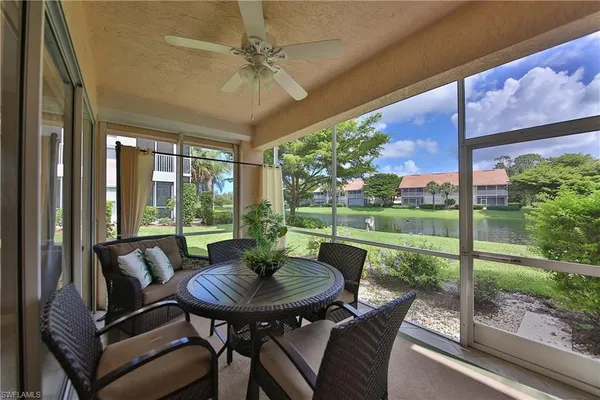 a view of a patio with a table chairs and a backyard