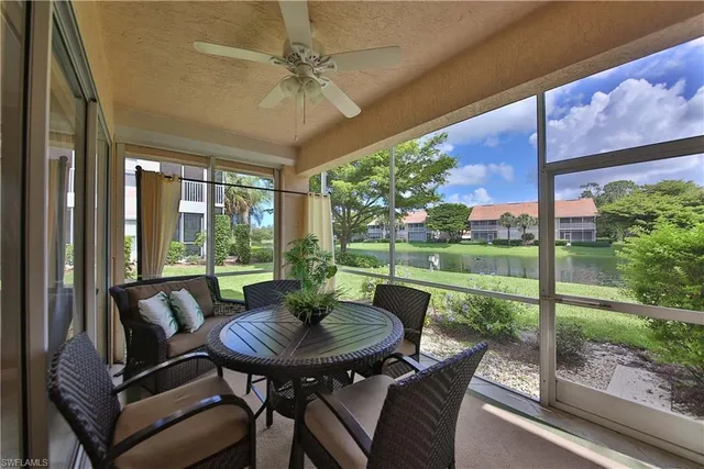 a view of a patio with a table chairs and a backyard