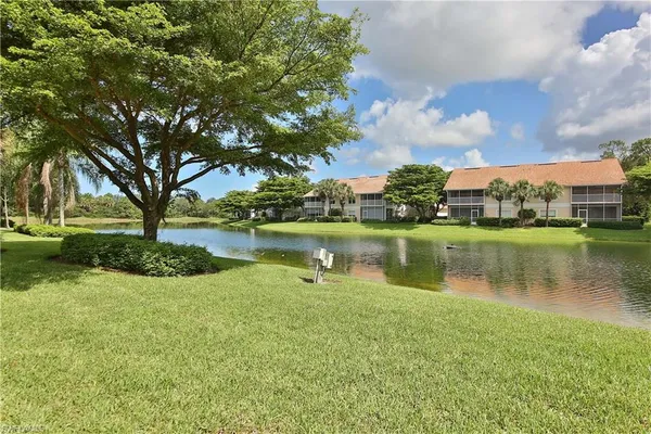 a view of a lake with houses in background