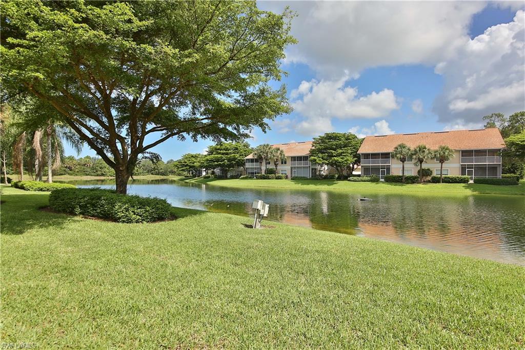5105 Cedar Springs Drive, Unit 101 Naples, FL 34110 - Photo 30 of 30 a view of a lake with houses in background