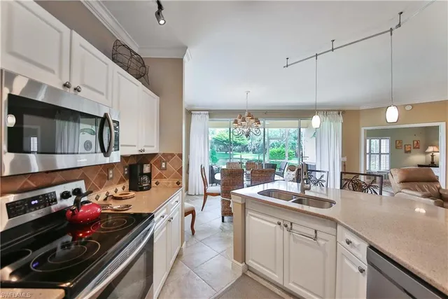 a kitchen with a stove a sink and a microwave