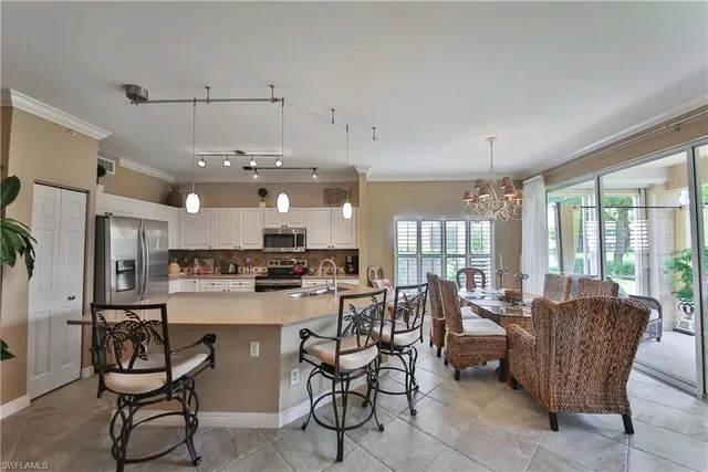 a room with stainless steel appliances kitchen island granite countertop furniture and a view of kitchen