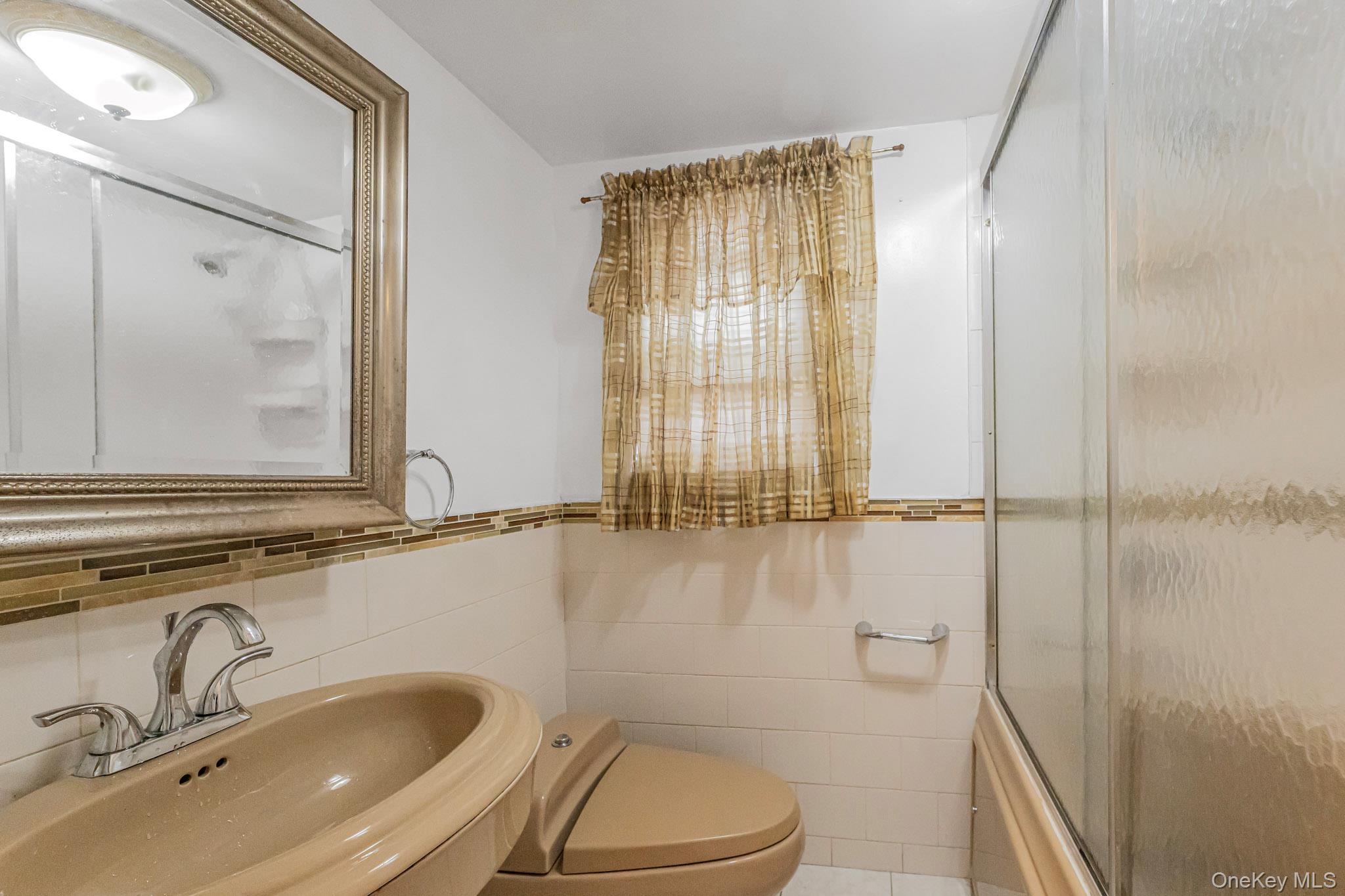 90-06 107th Avenue Queens, NY 11417 - Photo 7 of 13 a bathroom with a sink and a tub