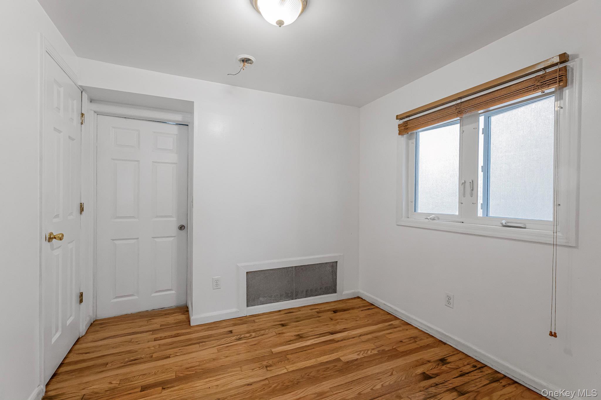 90-06 107th Avenue Queens, NY 11417 - Photo 8 of 13 a view of empty room with wooden floor and fan