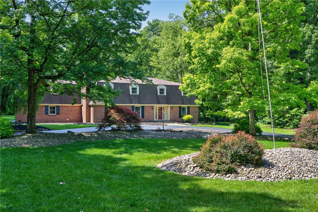 1371 Stoke Park Road Bethlehem, PA 18017 - Photo 3 of 55 a front view of a house with a garden and trees
