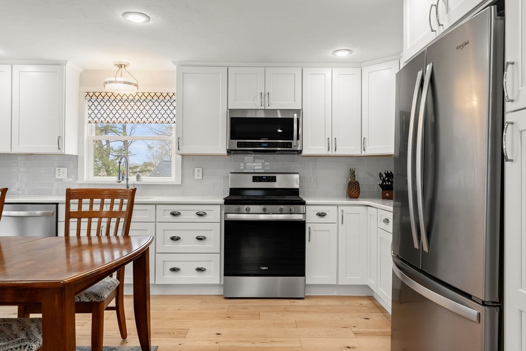 19 Overlook Road Holbrook, MA 02343 - Photo 11 of 42 a kitchen with stainless steel appliances a stove a refrigerator a sink a stove a dining table and chairs