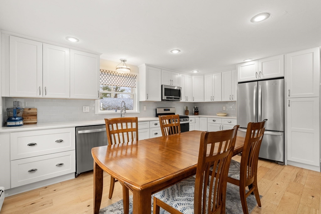 19 Overlook Road Holbrook, MA 02343 - Photo 13 of 42 a kitchen with stainless steel appliances granite countertop a stove a refrigerator a kitchen island a table and chairs
