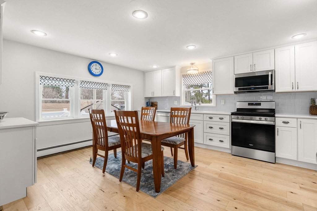 19 Overlook Road Holbrook, MA 02343 - Photo 10 of 42 a kitchen with stainless steel appliances granite countertop a kitchen island hardwood floor sink stove dining table and chairs