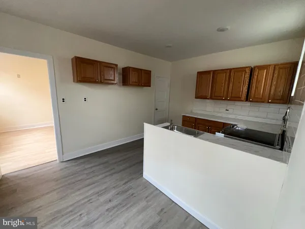 a kitchen with wooden floor and a microwave