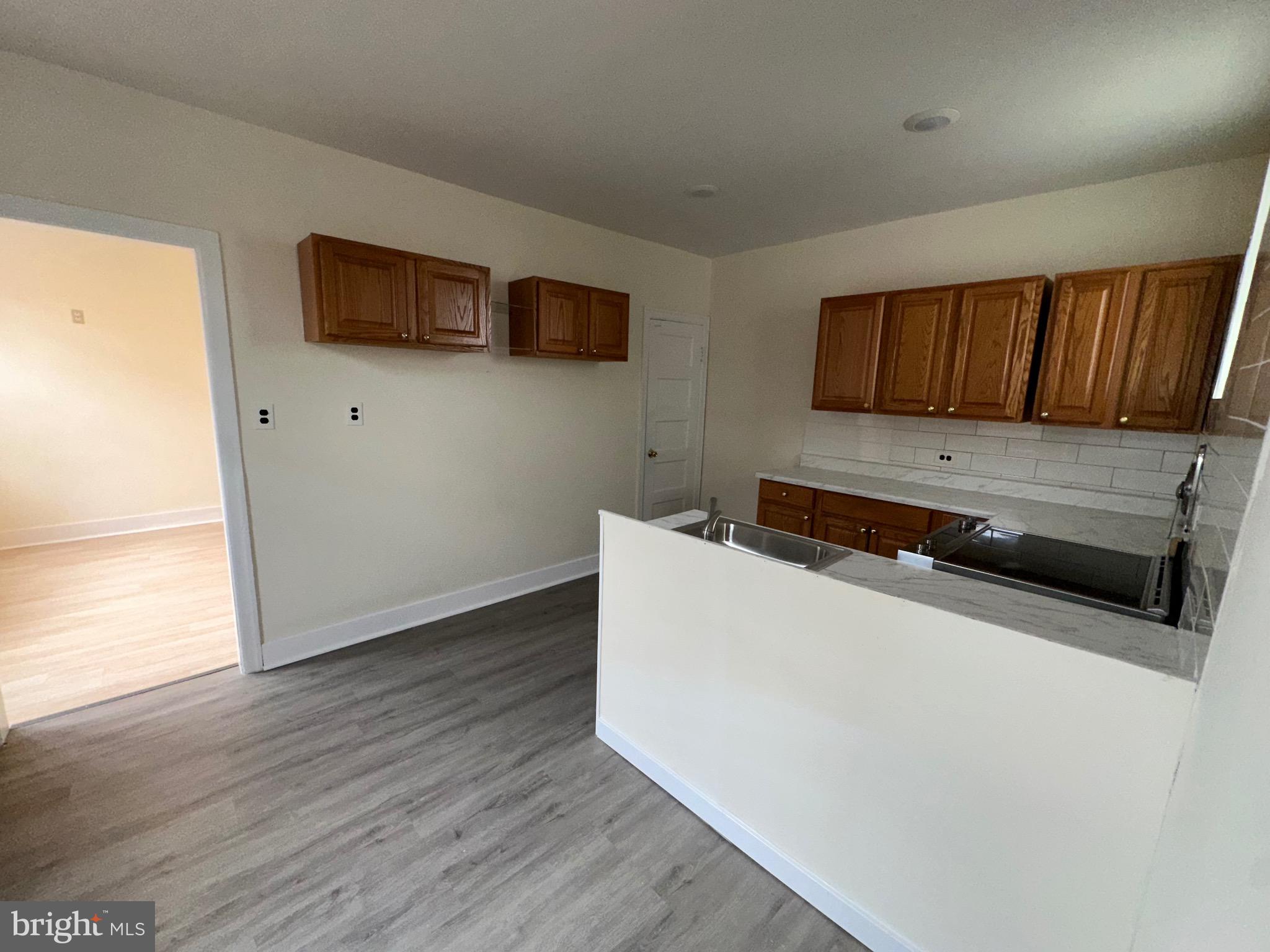 5426 North Front Street Philadelphia, PA 19120 - Photo 13 of 23 a kitchen with wooden floor and a microwave