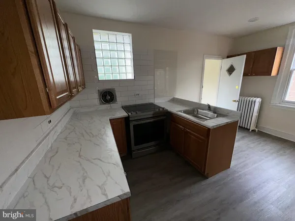a kitchen with a stove and a refrigerator