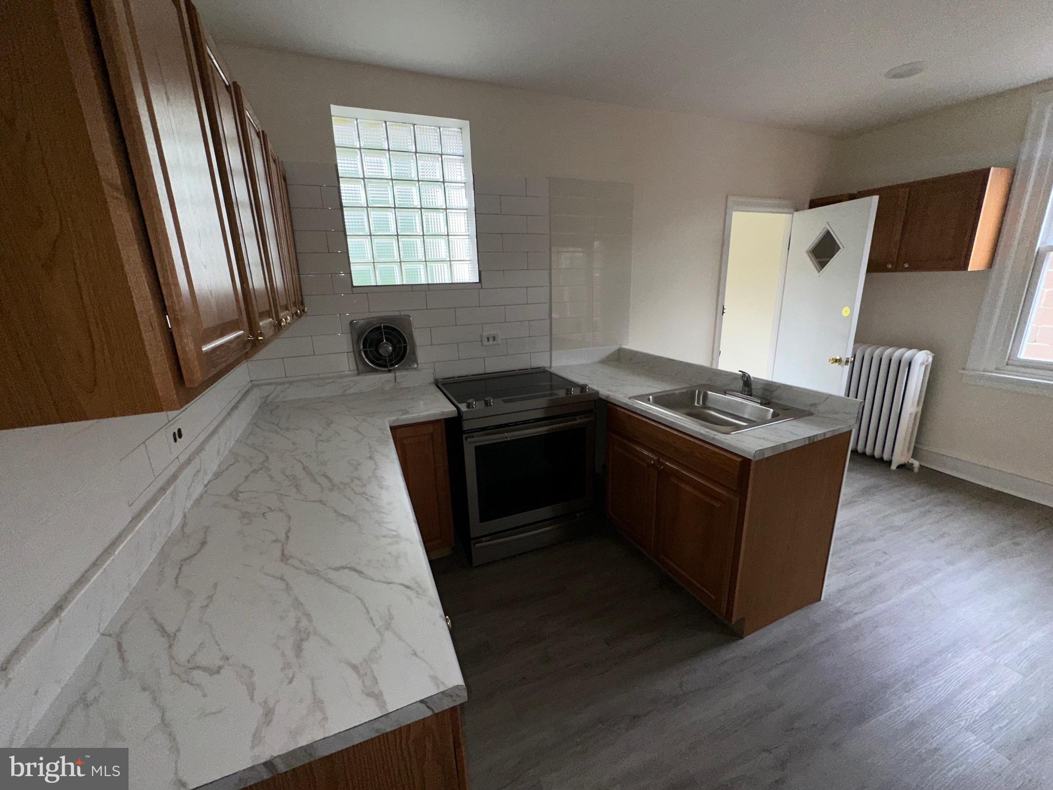 5426 North Front Street Philadelphia, PA 19120 - Photo 14 of 23 a kitchen with a stove and a refrigerator