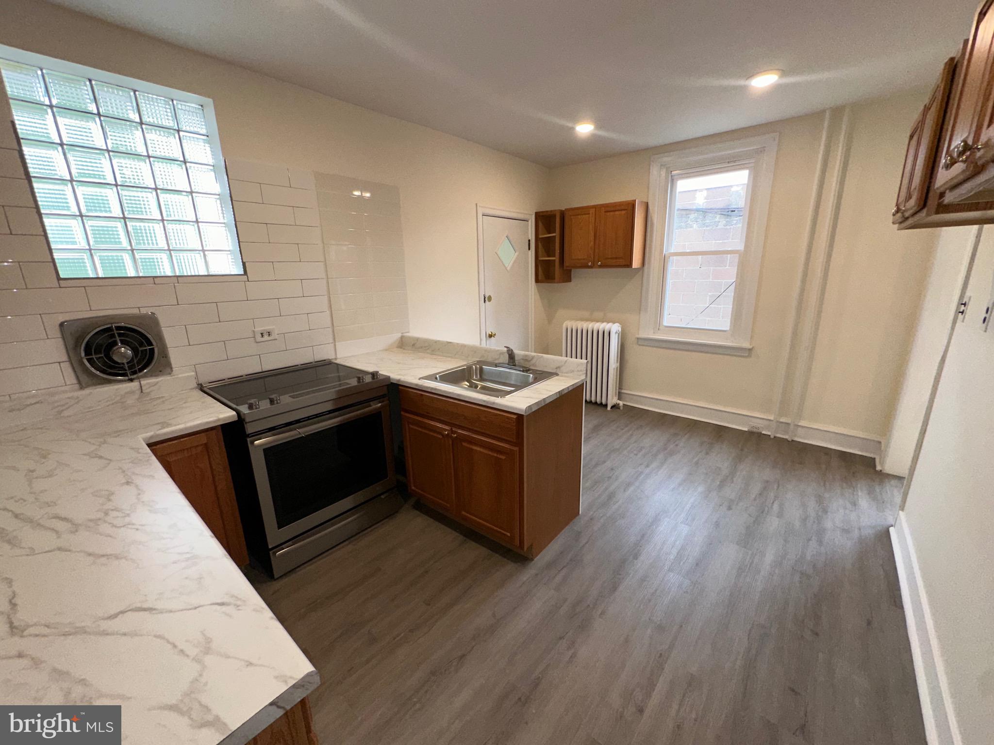 5426 North Front Street Philadelphia, PA 19120 - Photo 15 of 23 a kitchen with stainless steel appliances granite countertop a stove a sink and a microwave