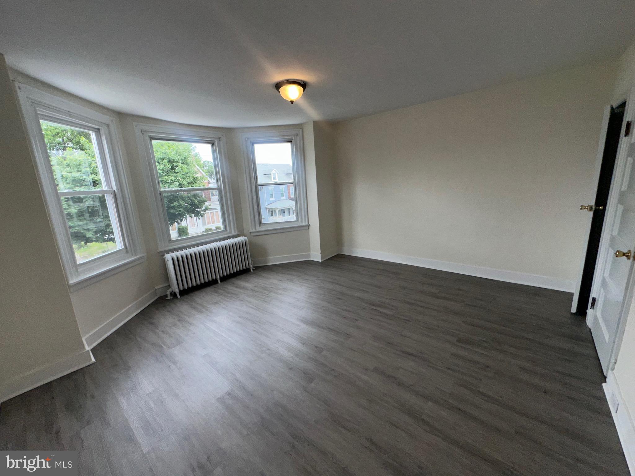 5426 North Front Street Philadelphia, PA 19120 - Photo 18 of 23 a view of an empty room with wooden floor and a window