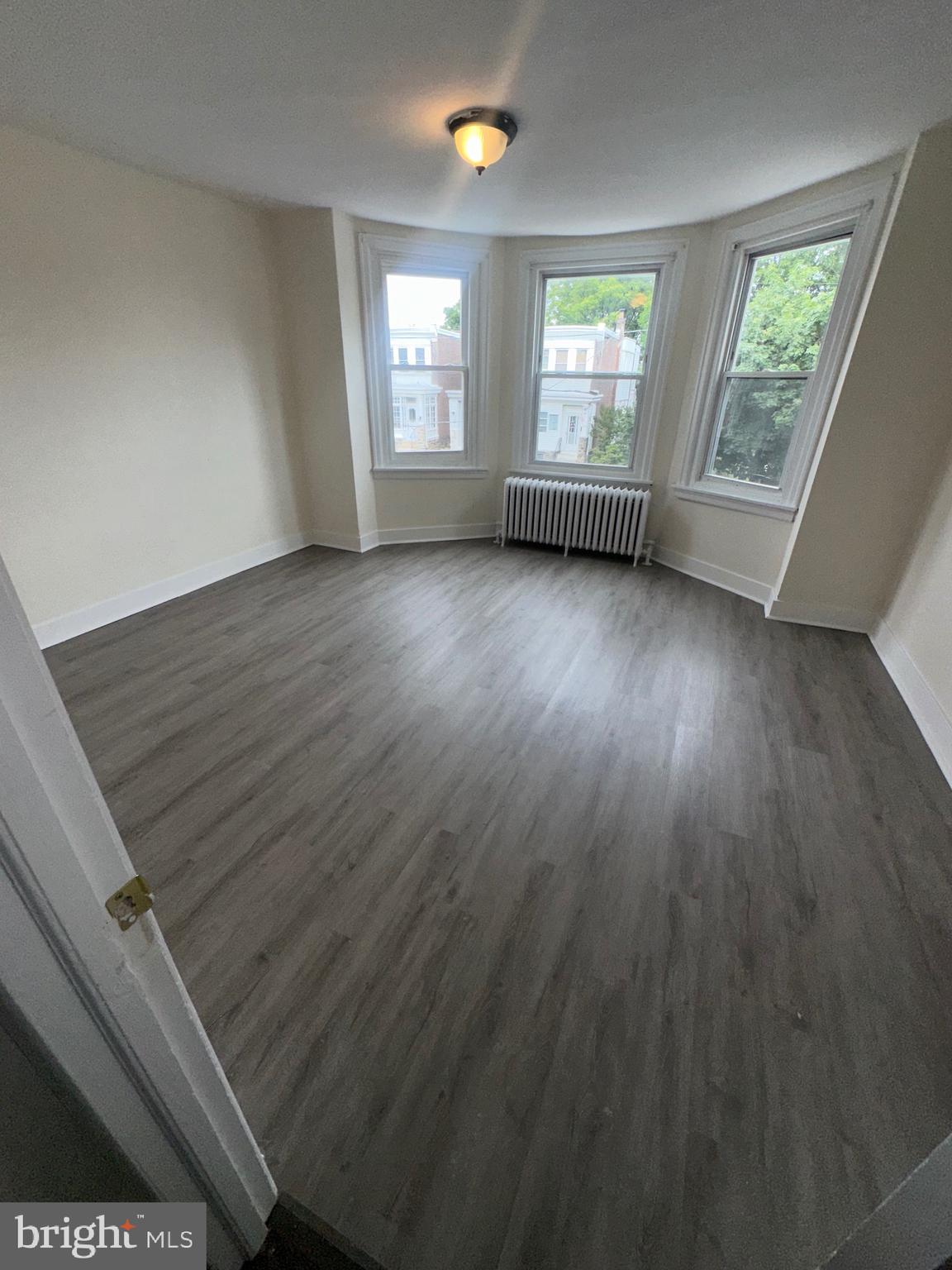 5426 North Front Street Philadelphia, PA 19120 - Photo 19 of 23 an empty room with wooden floor and windows