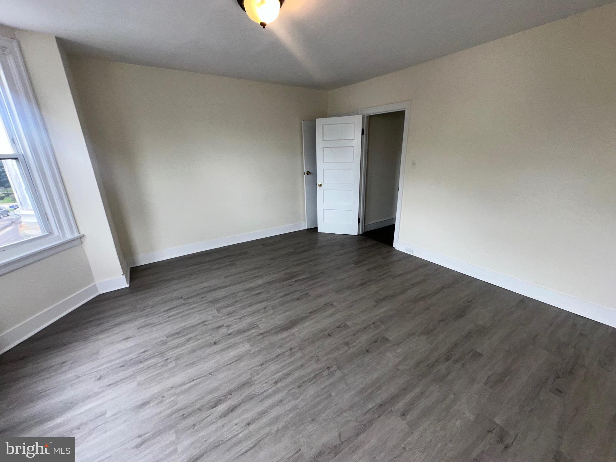 5426 North Front Street Philadelphia, PA 19120 - Photo 20 of 23 an empty room with wooden floor and windows