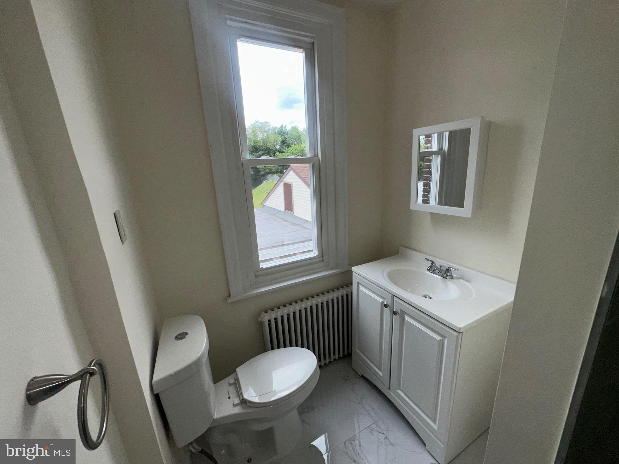 5426 North Front Street Philadelphia, PA 19120 - Photo 23 of 23 a bathroom with a sink toilet and window