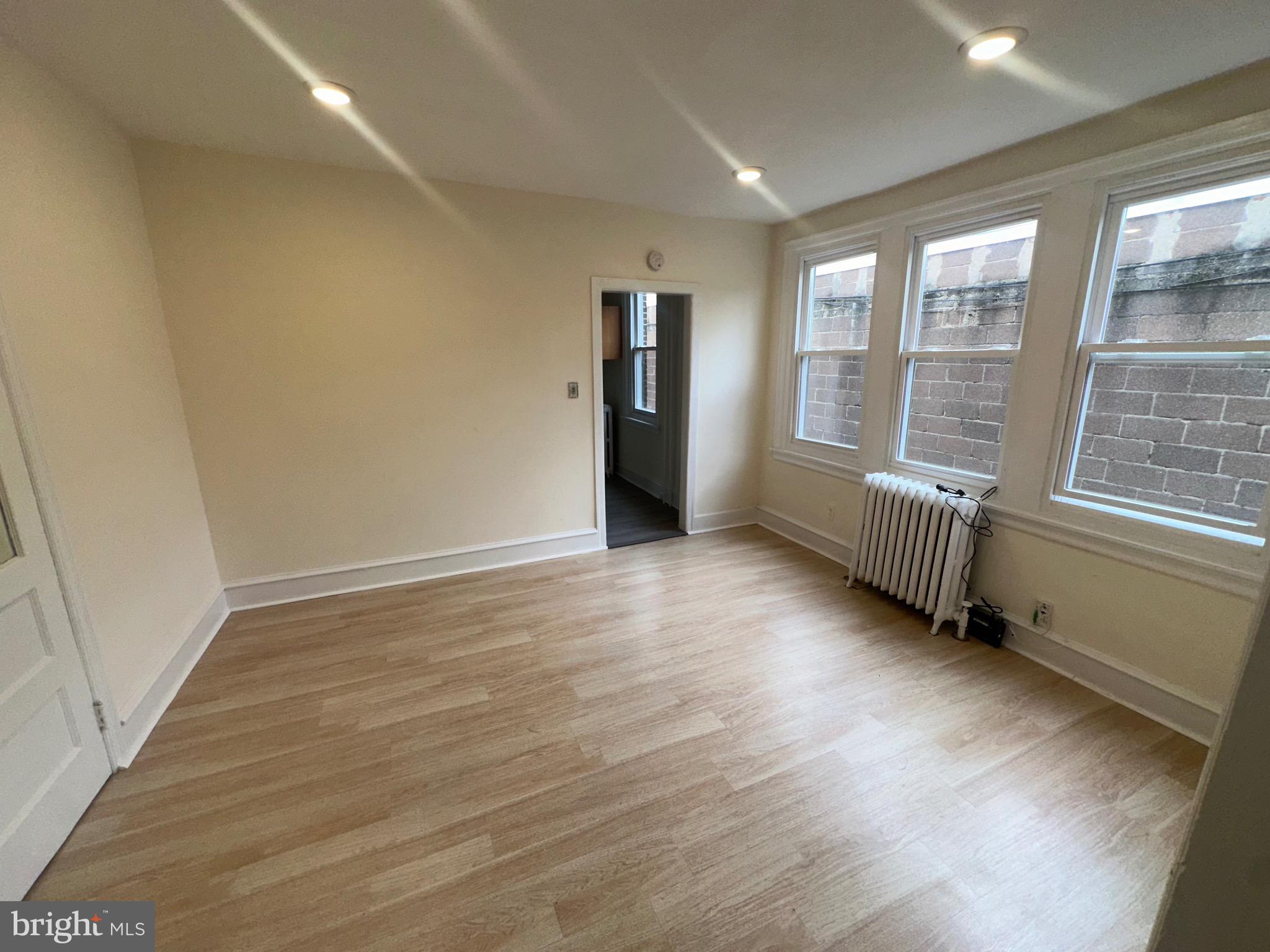 5426 North Front Street Philadelphia, PA 19120 - Photo 10 of 23 an empty room with wooden floor and windows