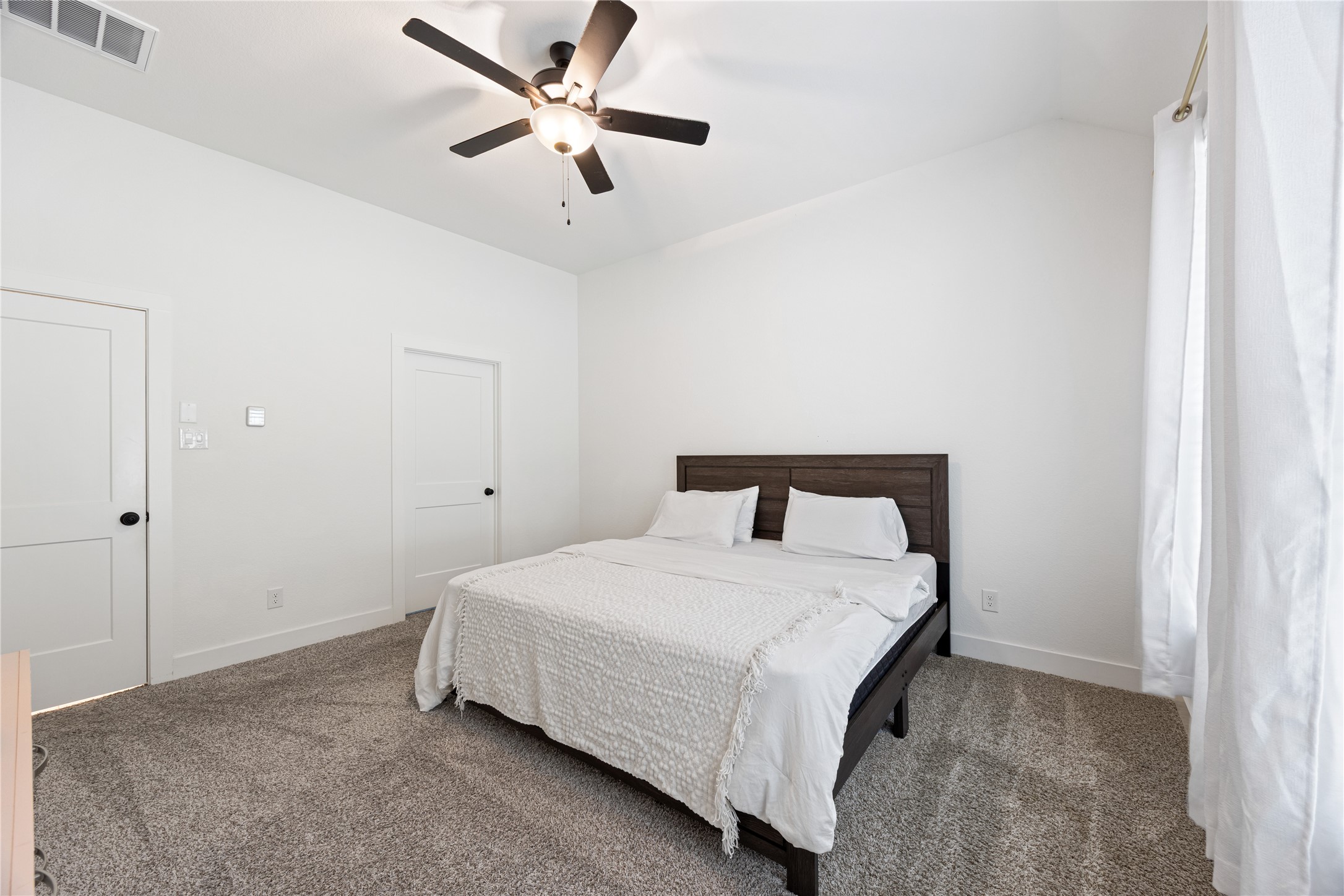 10636 Wild Chives Conroe, TX 77385 - Photo 16 of 29 a bedroom with a bed and a ceiling fan