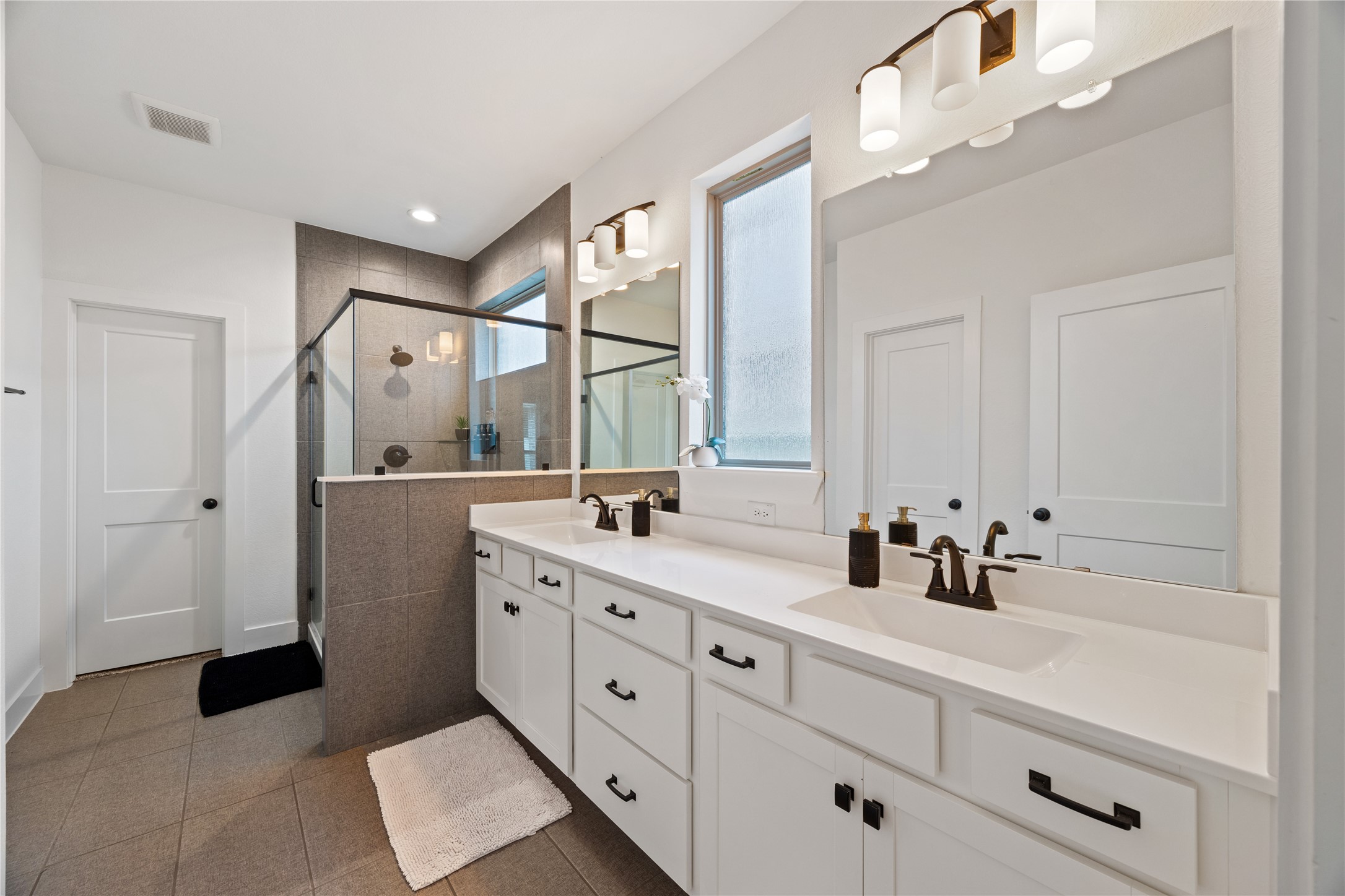 10636 Wild Chives Conroe, TX 77385 - Photo 17 of 29 a bathroom with a double vanity sink and mirror