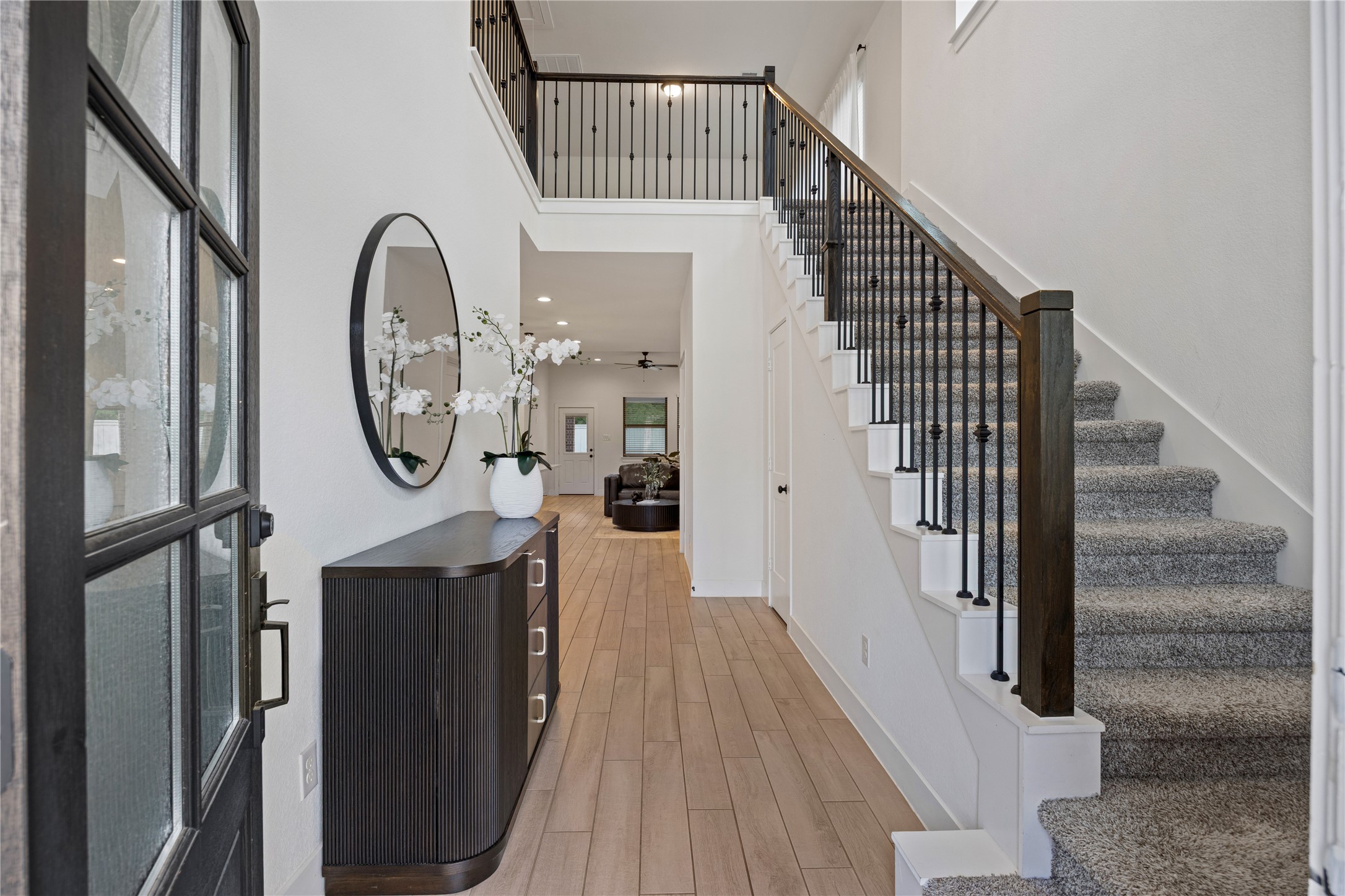 10636 Wild Chives Conroe, TX 77385 - Photo 4 of 29 a view of a hallway with wooden floor and entryway