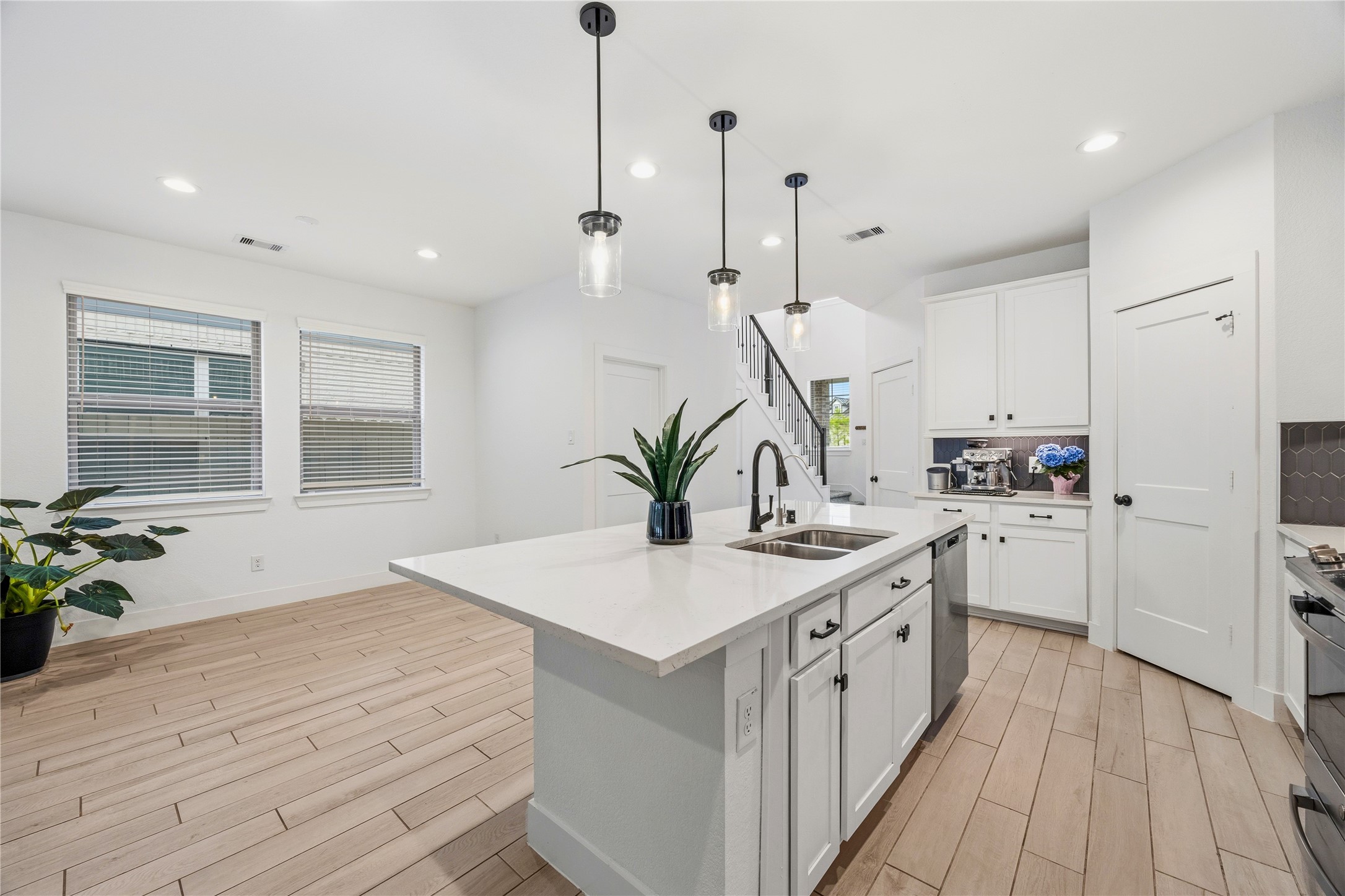 10636 Wild Chives Conroe, TX 77385 - Photo 9 of 29 a kitchen with a sink a stove and cabinets