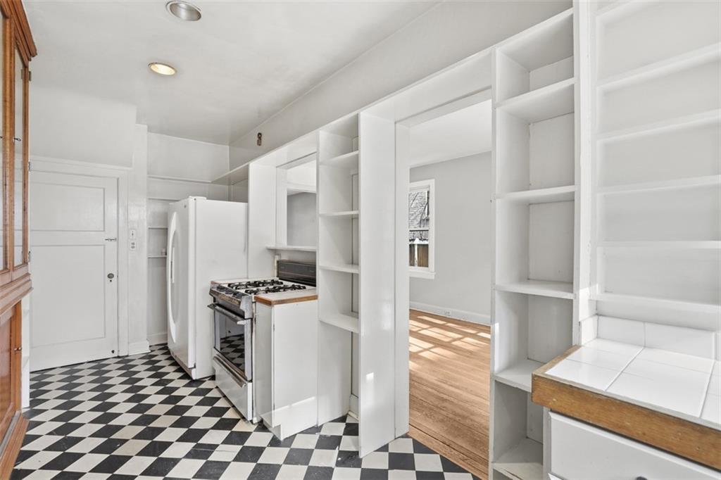 5928 Kentucky Avenue Pittsburgh, PA 15232 - Photo 17 of 40 a kitchen with granite countertop a stove and a refrigerator
