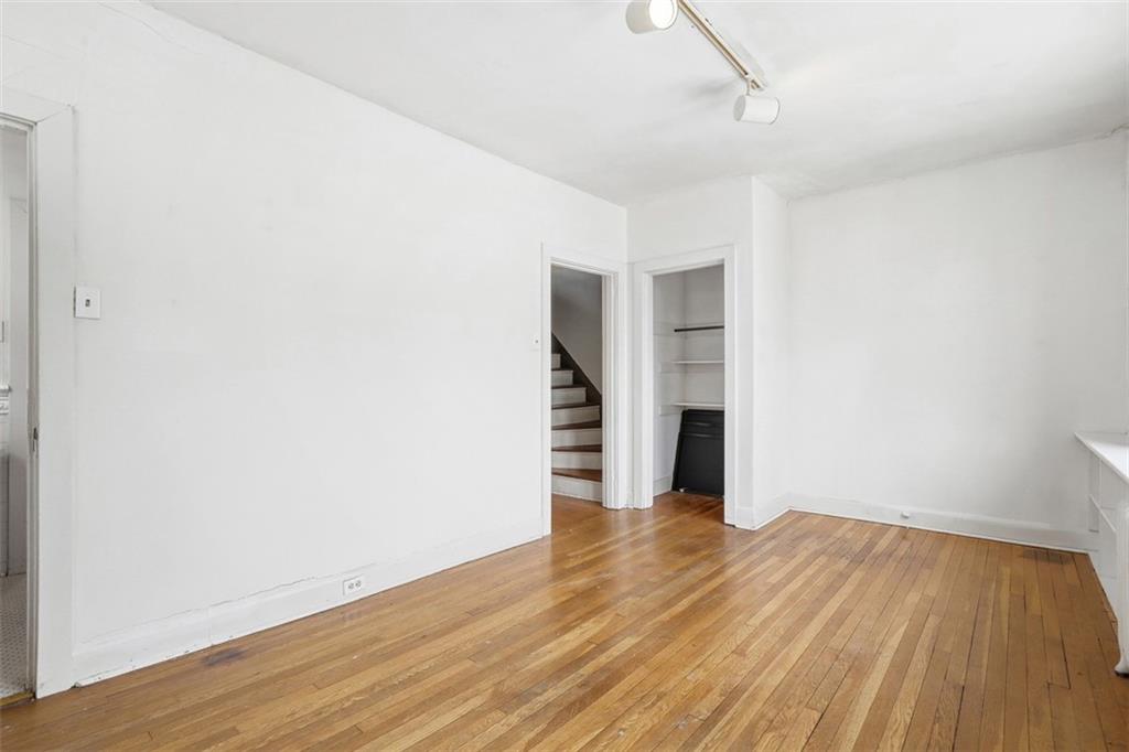 5928 Kentucky Avenue Pittsburgh, PA 15232 - Photo 27 of 40 a view of a big room with wooden floor and a ceiling fan