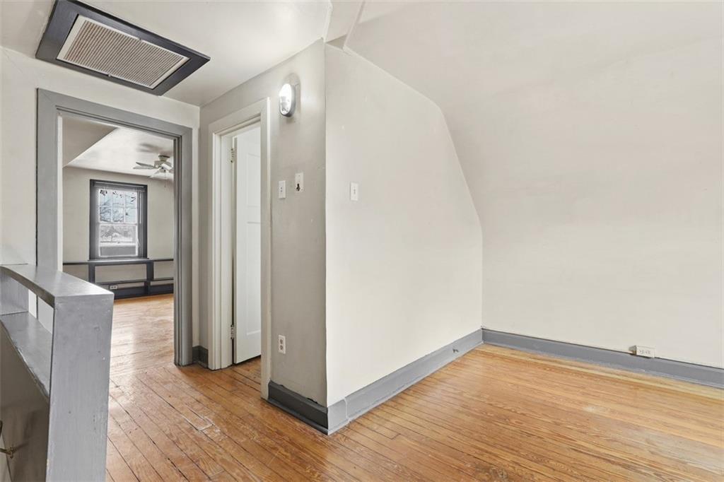 5928 Kentucky Avenue Pittsburgh, PA 15232 - Photo 28 of 40 a view of an empty room with wooden floor and a window