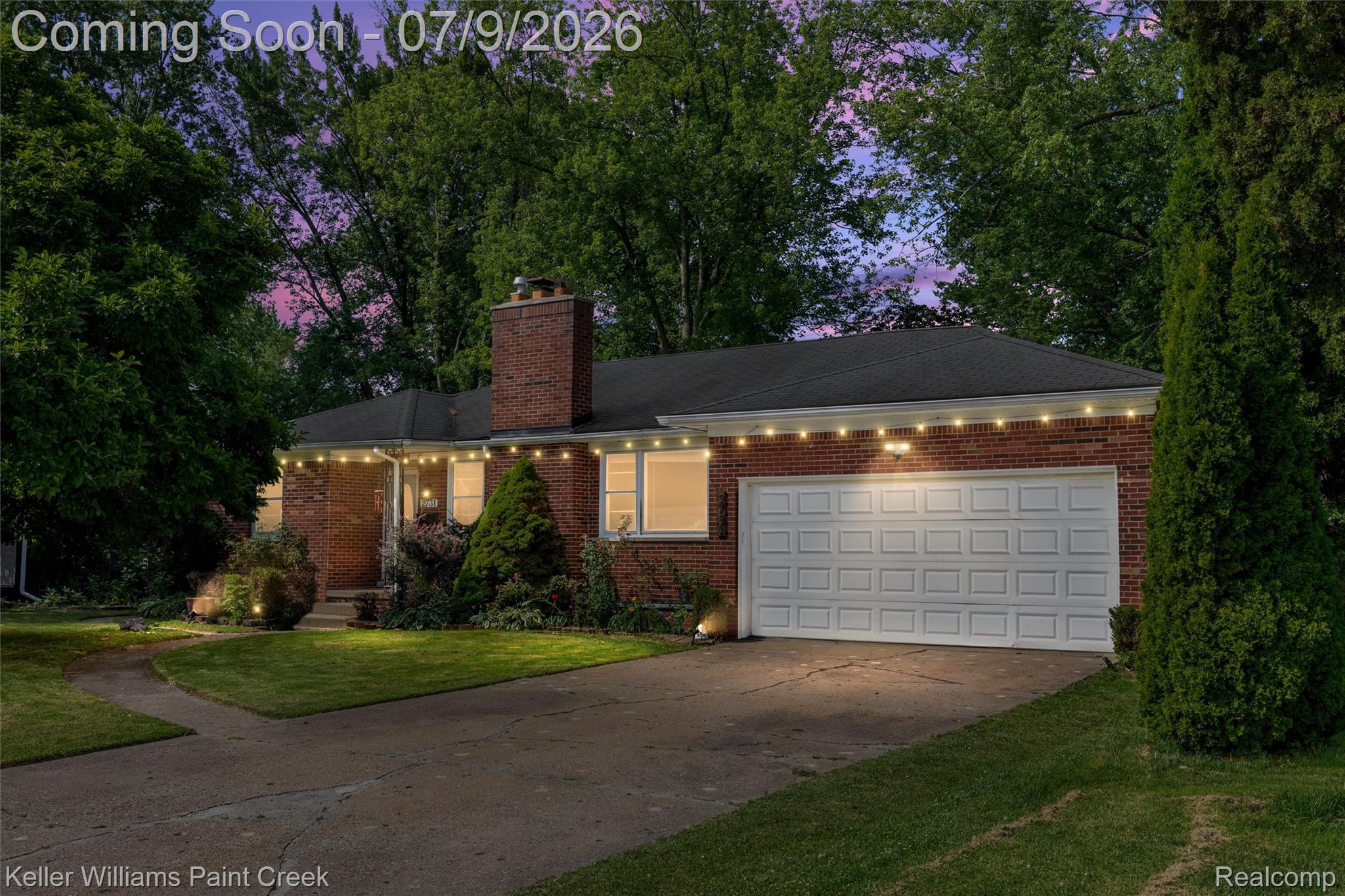 2731 Crooks Road Royal Oak, MI 48073 - Photo 1 of 34 Brick facade residence featuring an attached garage with a panelized door, a shingled roof, a prominent brick chimney, and mature landscaping