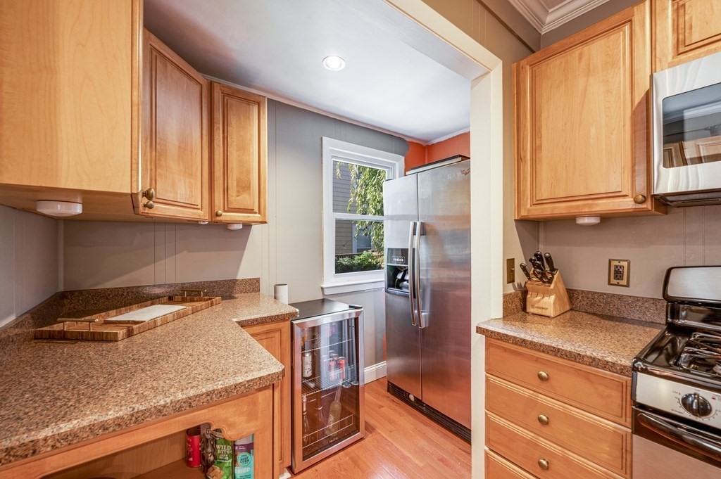 98 Reed Street Cambridge, MA 02140 - Photo 11 of 32 a kitchen with stainless steel appliances granite countertop a stove a sink and a microwave