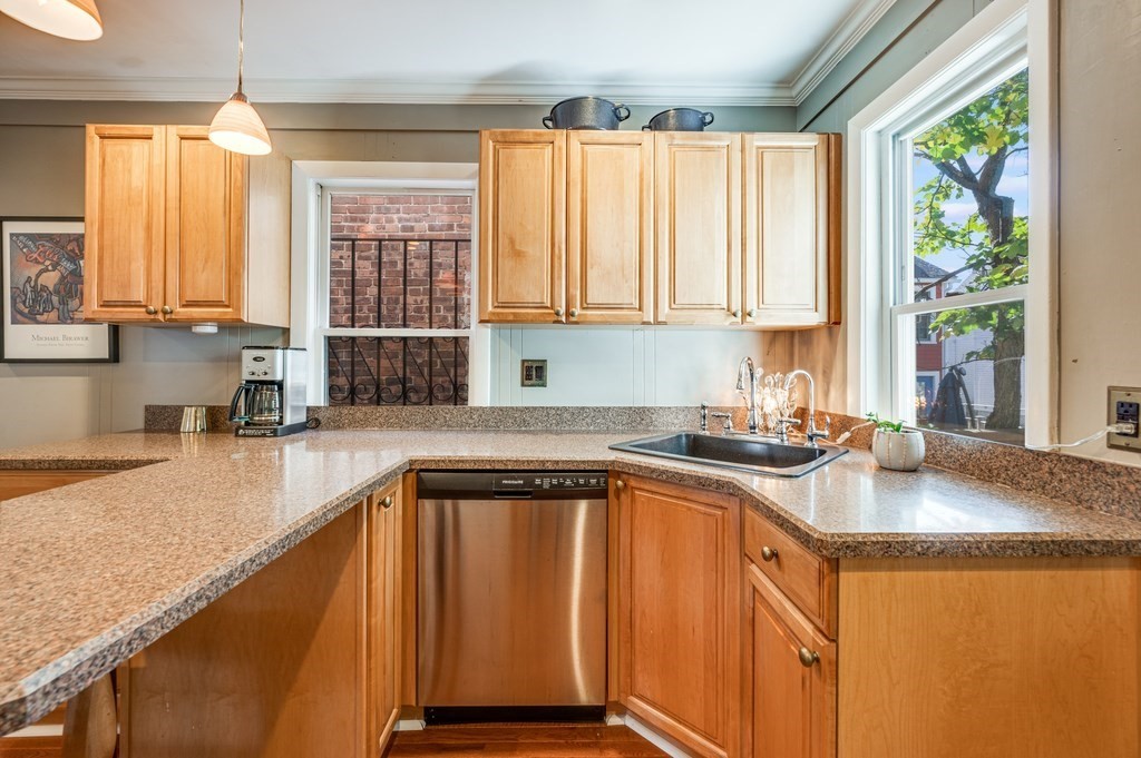 98 Reed Street Cambridge, MA 02140 - Photo 12 of 32 a kitchen with a sink a window and cabinets