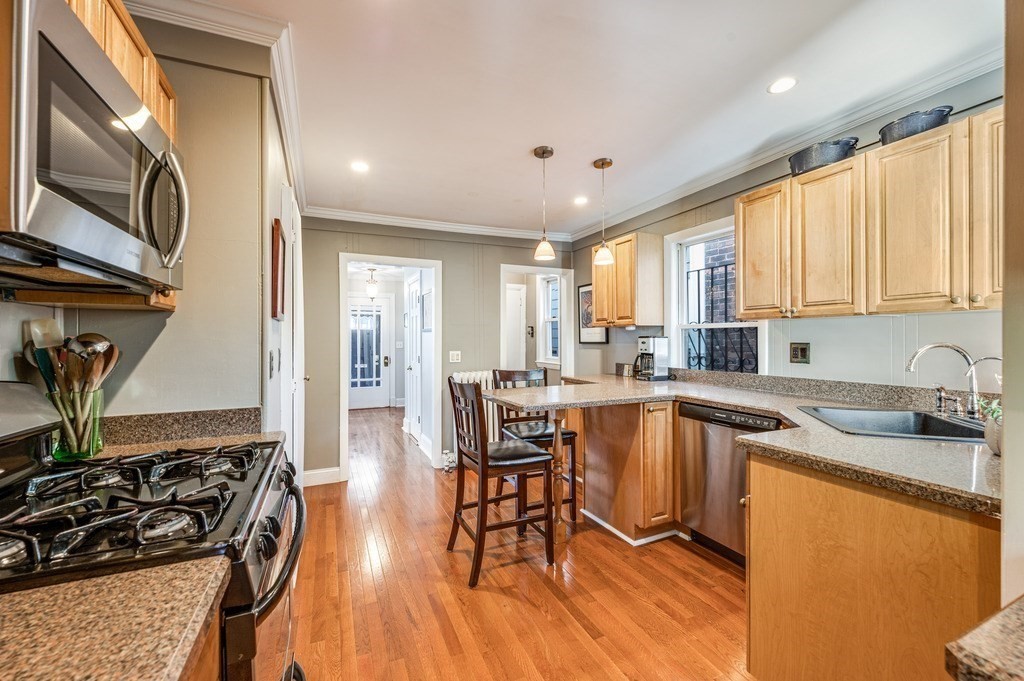 98 Reed Street Cambridge, MA 02140 - Photo 14 of 32 a kitchen with stainless steel appliances granite countertop sink stove top oven and cabinets