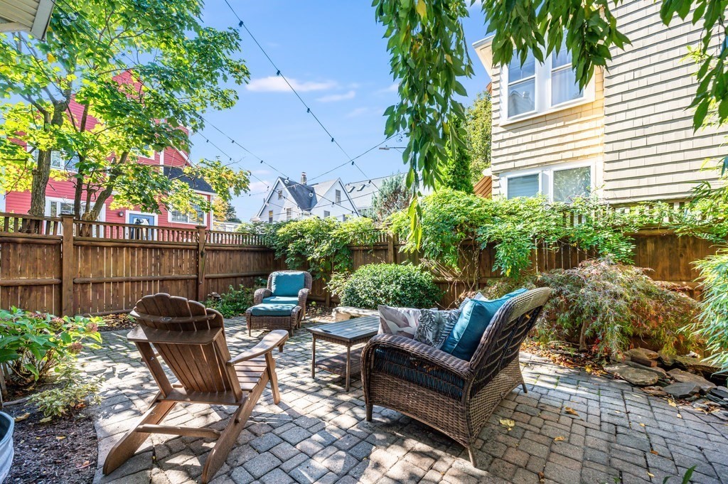 98 Reed Street Cambridge, MA 02140 - Photo 30 of 32 a view of a patio with table and chairs and potted plants