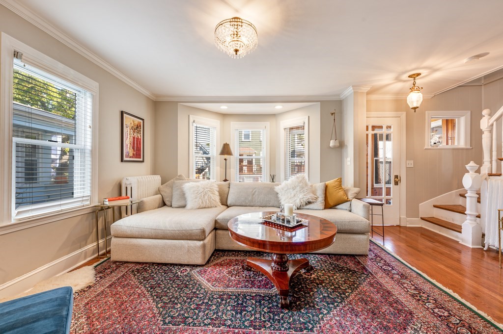 98 Reed Street Cambridge, MA 02140 - Photo 5 of 32 a living room with furniture a wooden floor and a large window