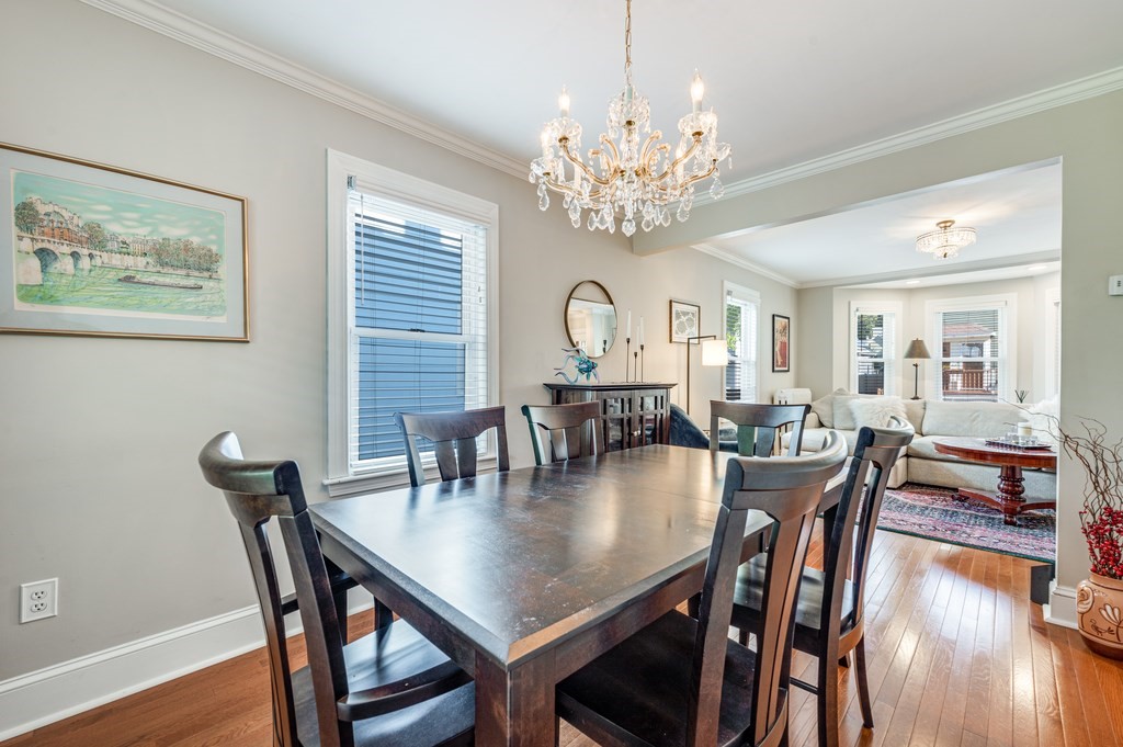 98 Reed Street Cambridge, MA 02140 - Photo 8 of 32 a view of a dining room with furniture a chandelier and wooden floor